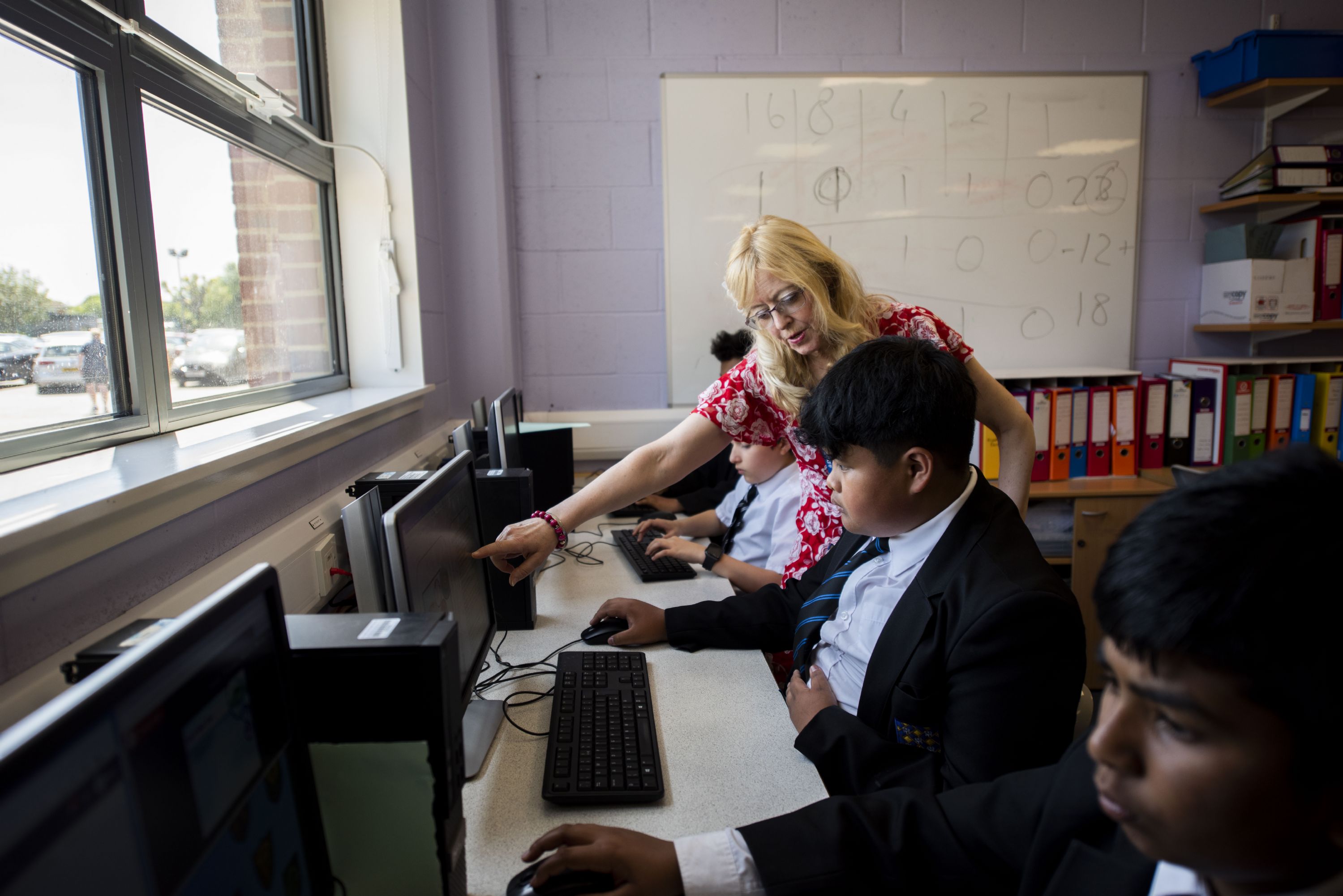 teacher and student in computer science lesson