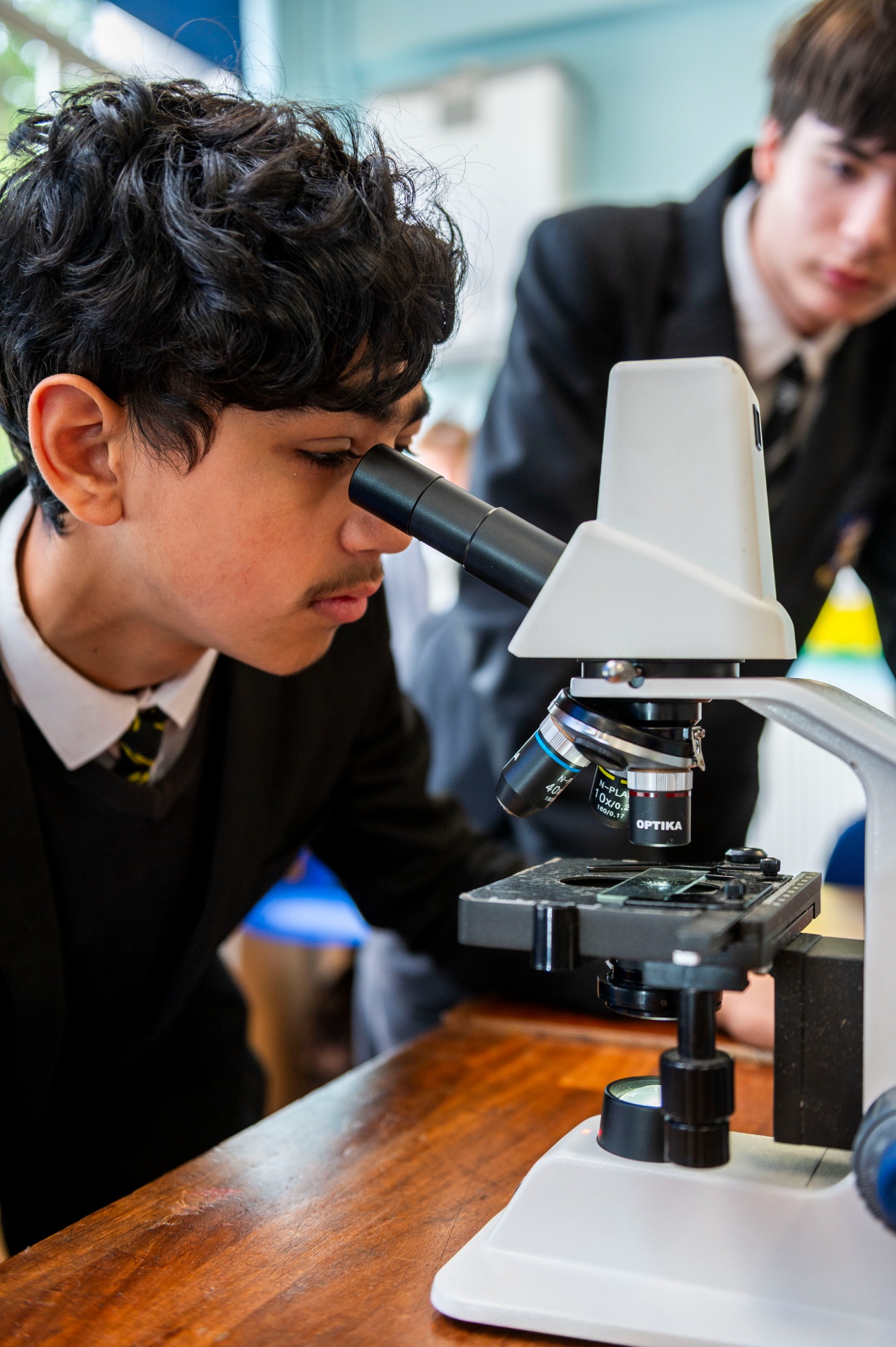 Student looking through a microscope