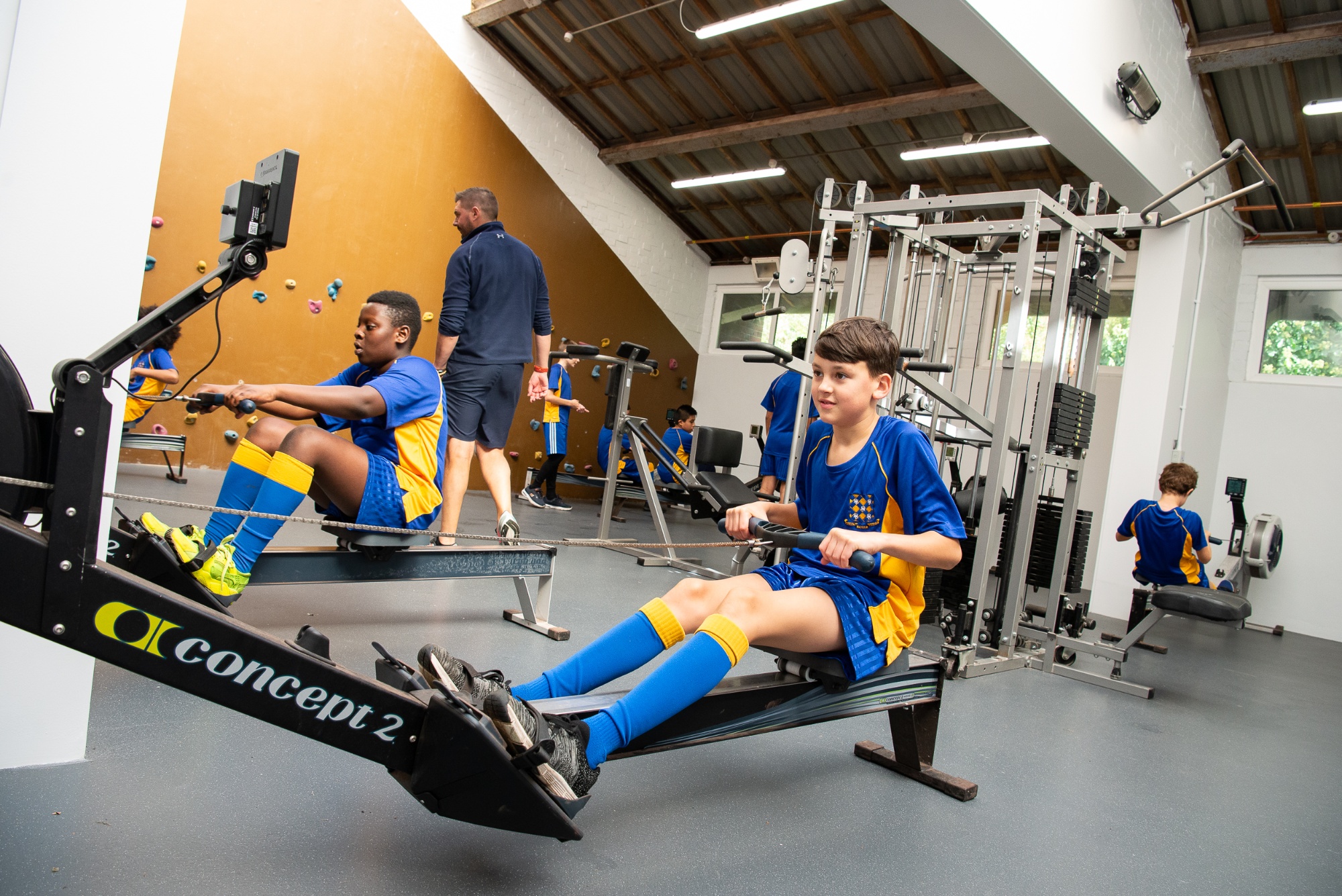 students on the indoor rowing machines