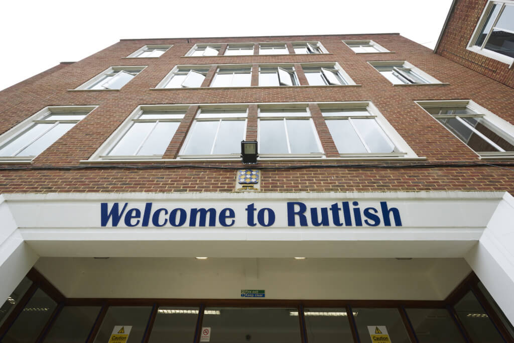 Min building with the welcome to rutlish sign